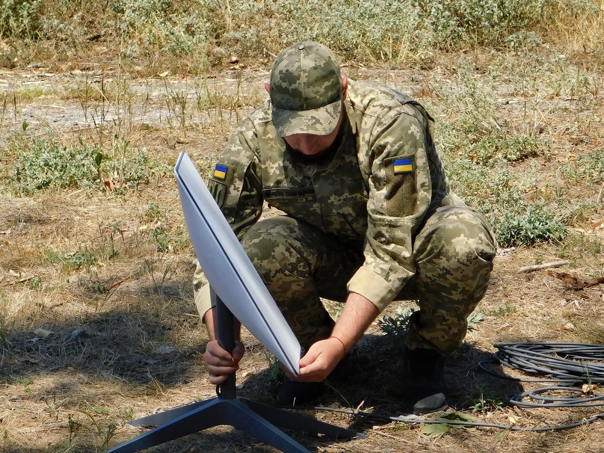 A soldier with Ukraine's Support Forces installs a Starlink terminal in July 2022.