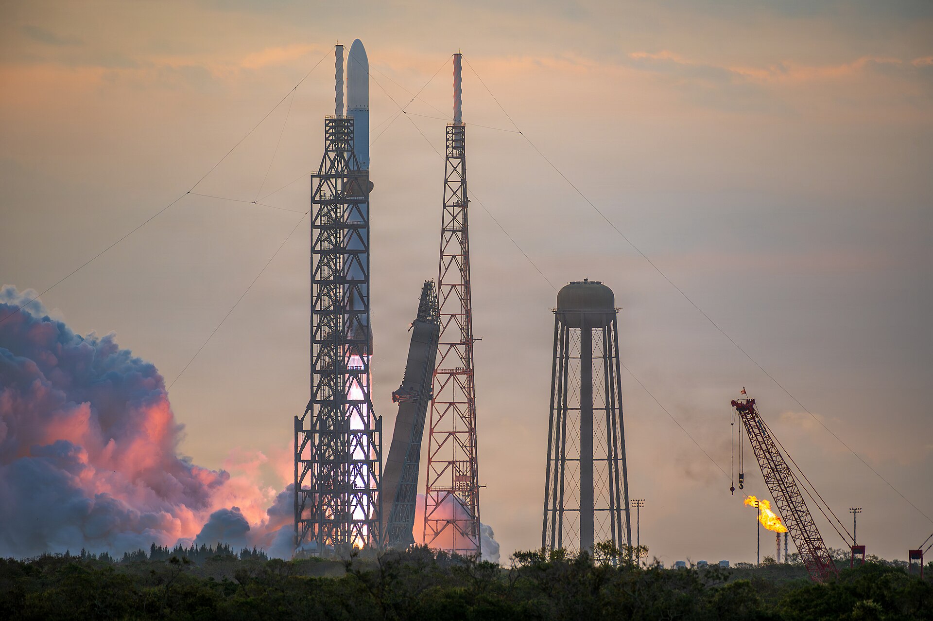 A New Glenn rocket lifts off beside the Vehicle Access Tower at Launch Complex 36 in Florida on the BlueBird 7 mission on April 19, 2026.