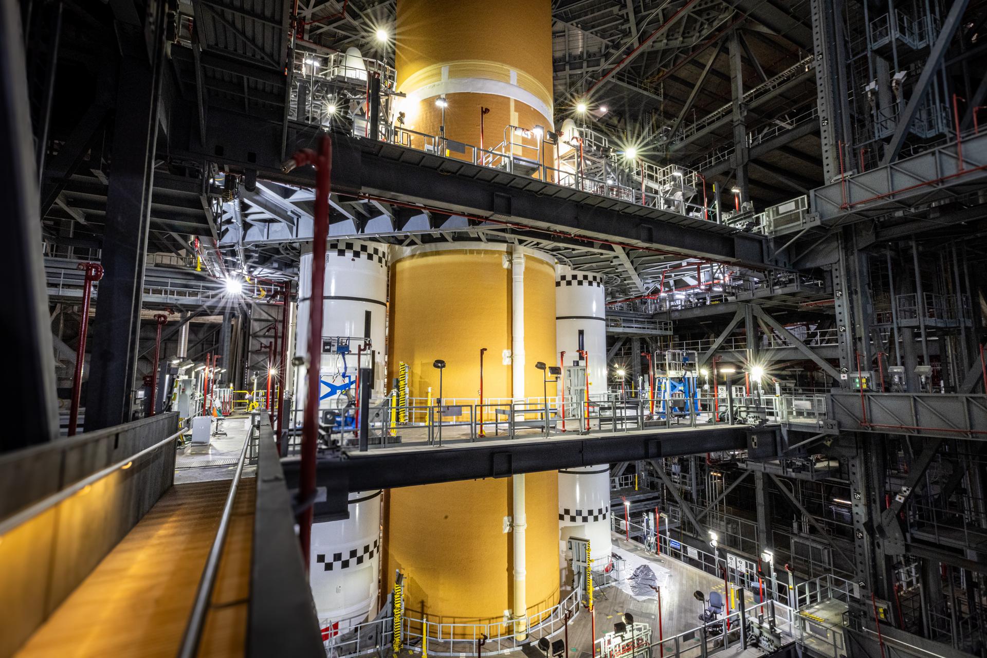 The Artemis III Space Launch System core stage stands integrated with its twin solid rocket boosters in High Bay 3 of the Vehicle Assembly Building a…